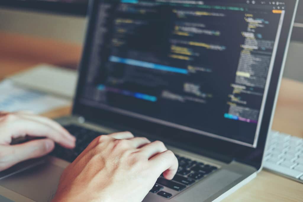 A person coding on the laptop