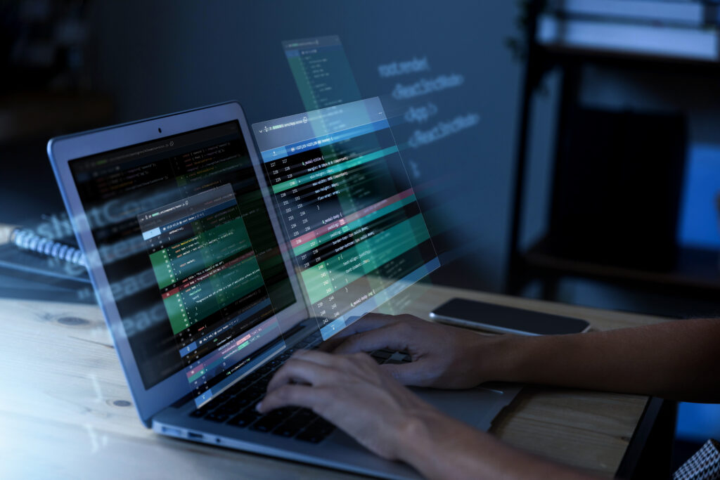 a person is coding in laptop